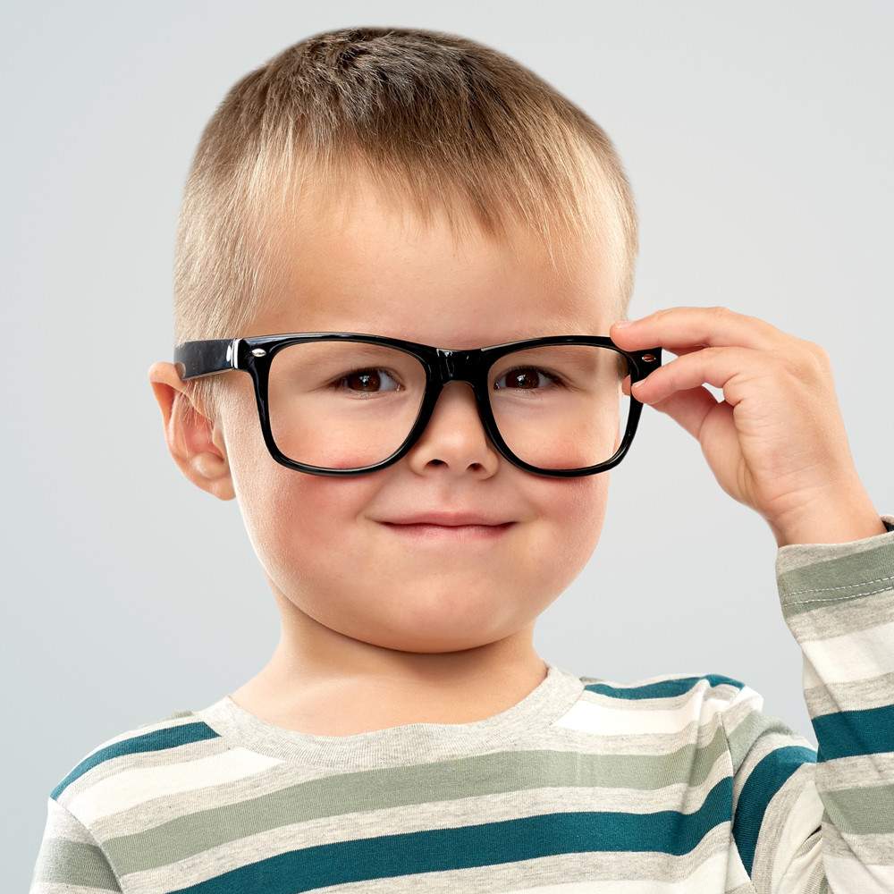 Young boy smiling wearing Glasses