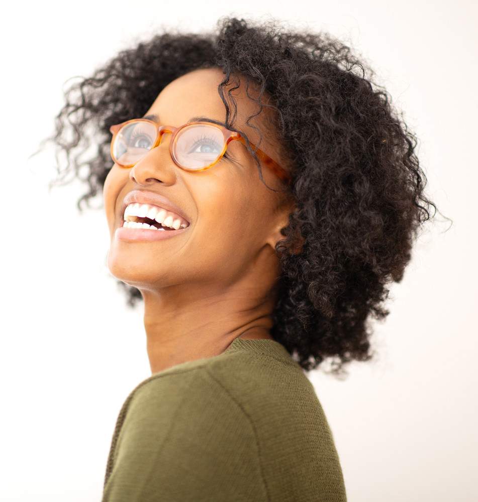 side portrait of smiling young woman with trendy eyeglasses.